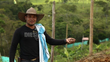 A member of the Llano Grande reincorporation zone shows the delegation some of the mini-agricultural projects being developed in the reincorporation zones. One of the principal concerns expressed during the delegation was the failure so far to provide demobilised guerrillas with any land.